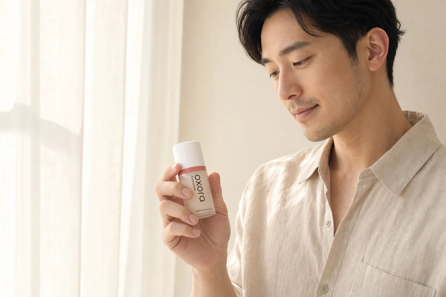 A man holding Oxora Acne-prone by a sunlit window